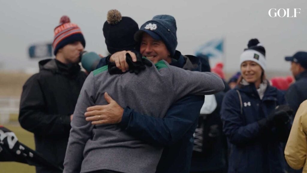 A Notre Dame player is embraced by a family member during the St. Andrews Links Collegiate.