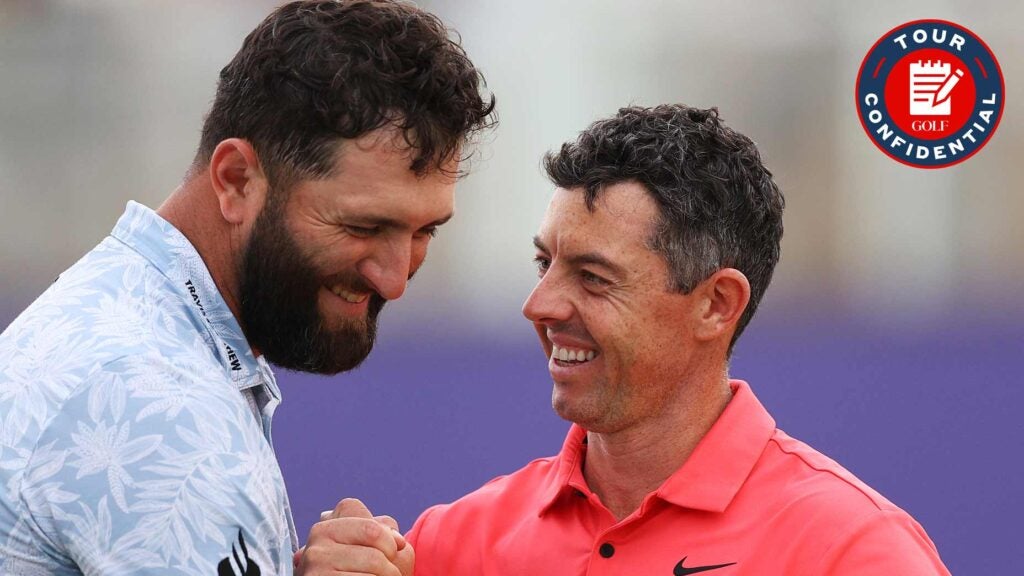 Jon Rahm shakes hands with Rory McIlroy in Dubai.