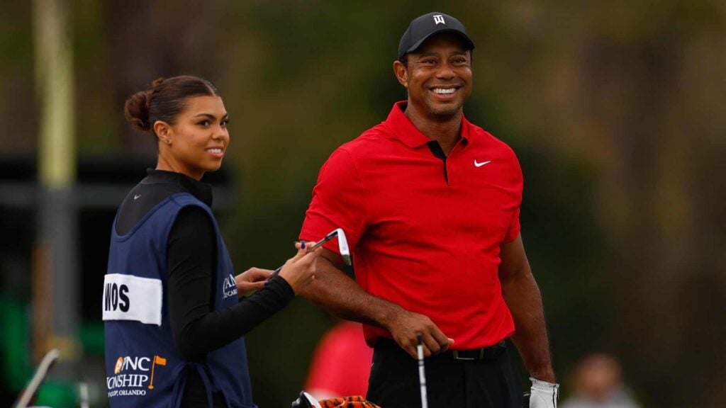 Tiger Woods and Sam Woods smile on the practice range at the PNC Championship.