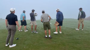 a group of golfers playing streamsong blue in a dense fog