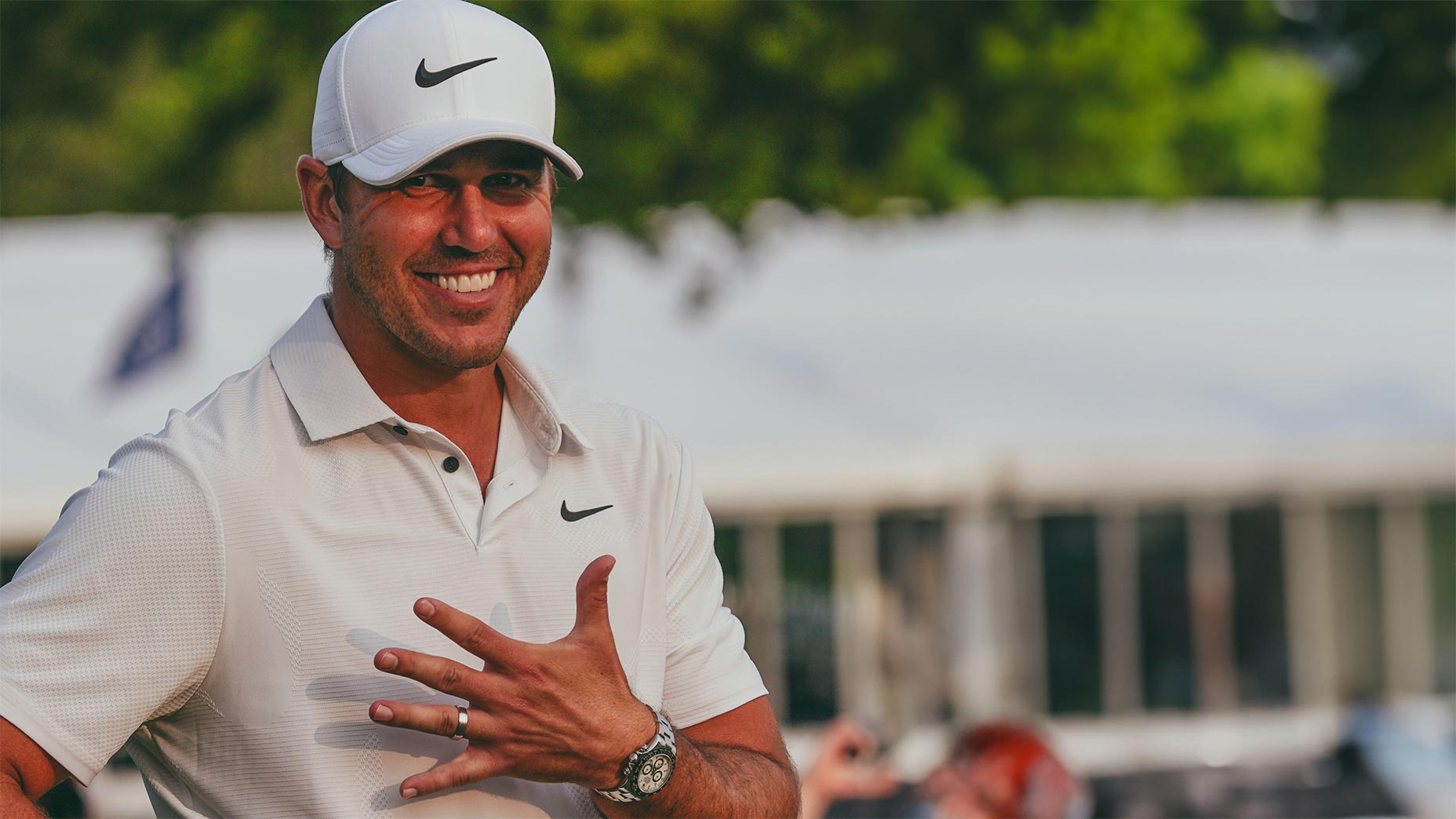 brooks koepka smiles holding up fist at pga championship