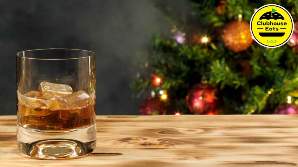 A glass of bourbon in a holiday setting