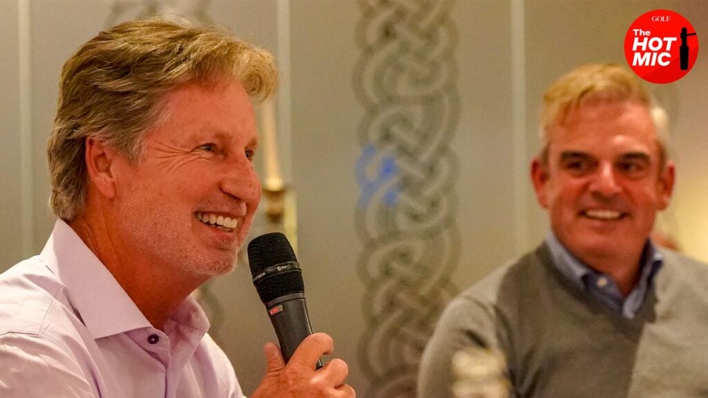 brandel chamblee and paul mcginley laugh on microphone at charity event