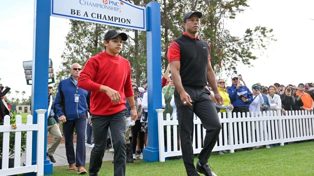 Tiger Woods and Charlie Woods enter the 1st tee area during the 2022 PNC Championship