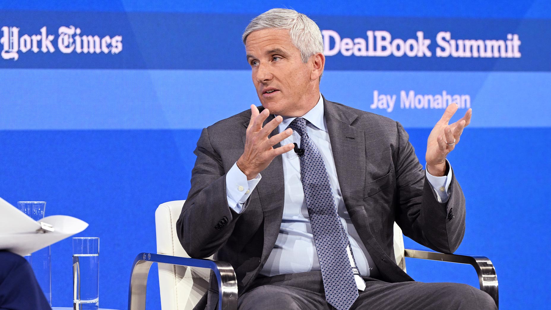 jay monahan speaks in gray suit from stage at NYT Dealbook summit.