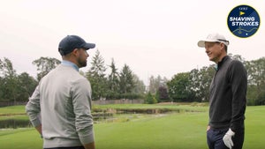 Parker McLachlin explains par-3 strategy to Nick Dimengo on golf course