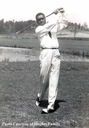 Solomon hughes sr takes a swing on the golf course