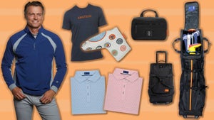 Man wearing a Stitch Golf quarter-zip pullover in navy blue, coupled with a variety of Stitch golf items that are on sale now. There's a t-shirt that says "AMATEUR," a putter cover with sushi rolls on it, 2 polos in blue and pink, a dopp kit in black and a travel bag that converts into a rolling duffle bag.