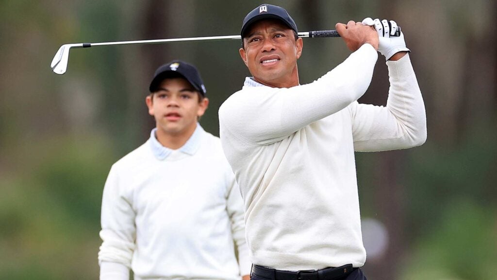 Tiger Woods hits a shot at 2022 PNC Championship as son Charlie Woods watches