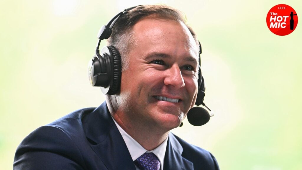 trevor immelman smiles from broadcast booth while wearing headset and and suit