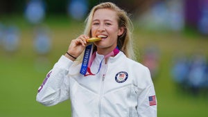 Nelly Korda bites her Olympic Gold Medal at the 2020 Olympics.