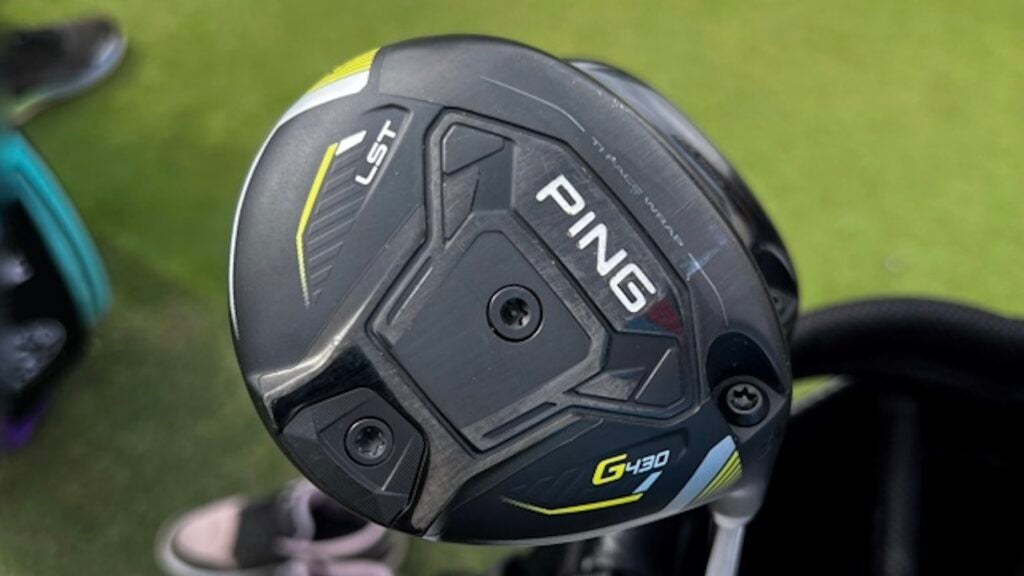 PING G430 LST 3-wood held in hand on a golf course