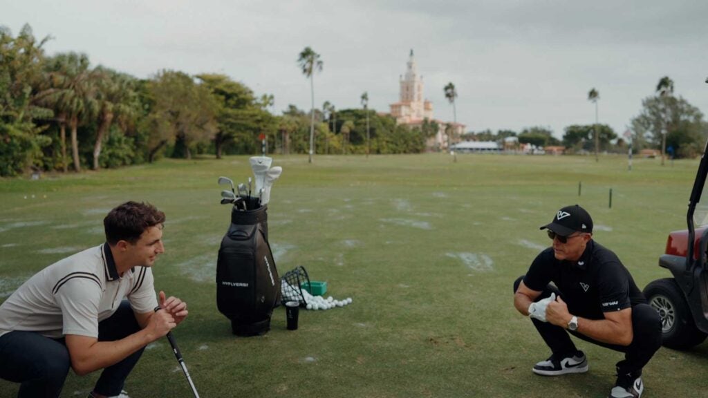 Phil Mickelson squatting with Dylan Dethier at LIV's content shoot.