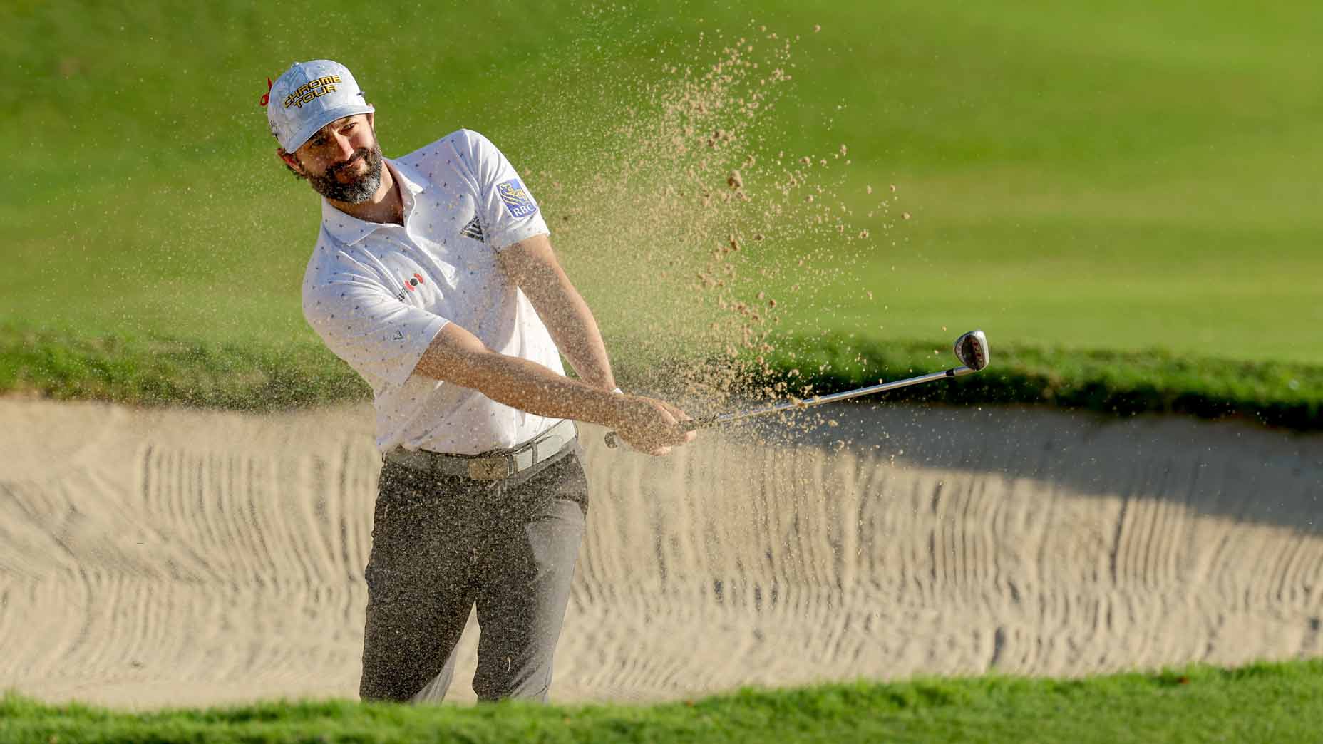 adam hadwin hits a shot out of the bunker during the 2024 Sony Open