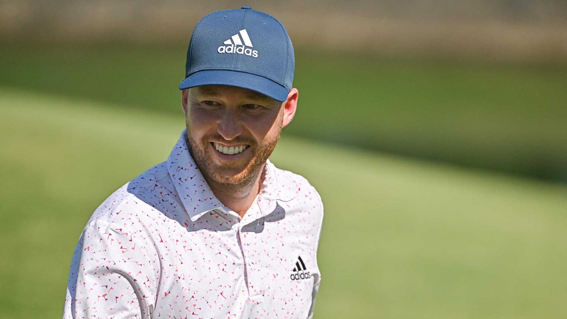 daniel berger smiles in adidas had and shirt at charles schwab challenge