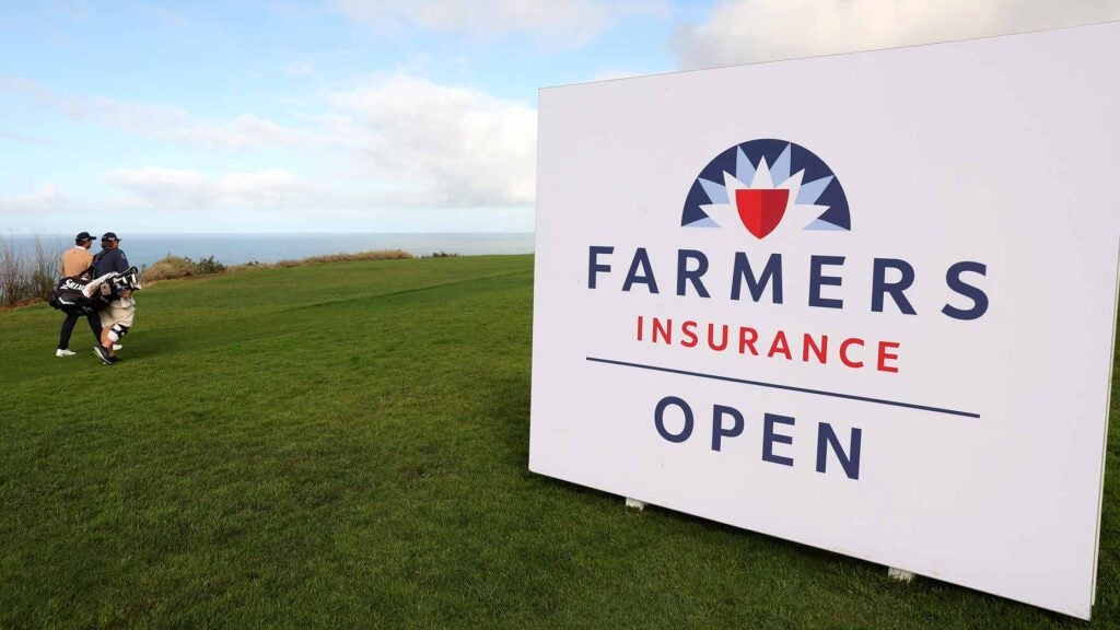 Players walk past Farmers Insurance Open sign at Torrey Pines