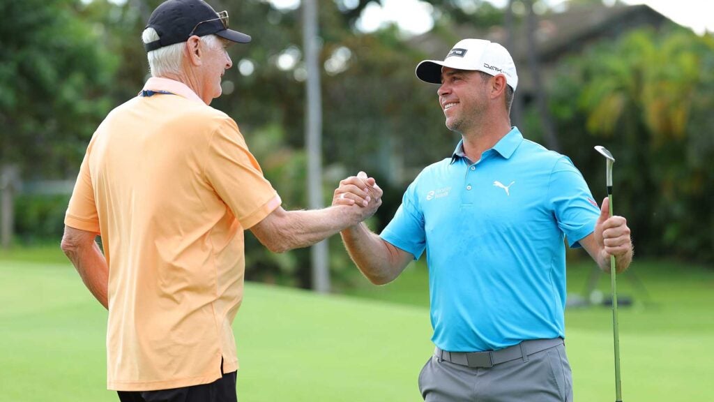 Gary Woodland shakes hands with Andy North on green at 2024 Sony Open
