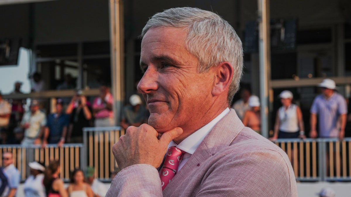 Jay Monahan, Commissioner of the PGA, watches as Viktor Hovland does interviews on the green of the 18th hole of the TOUR Championship at East Lake Golf Club