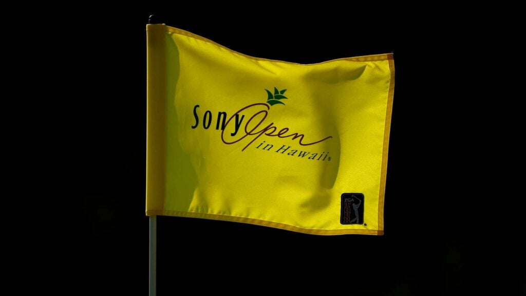Pin flag flaps in wind on green at 2022 Sony Open in Hawaii