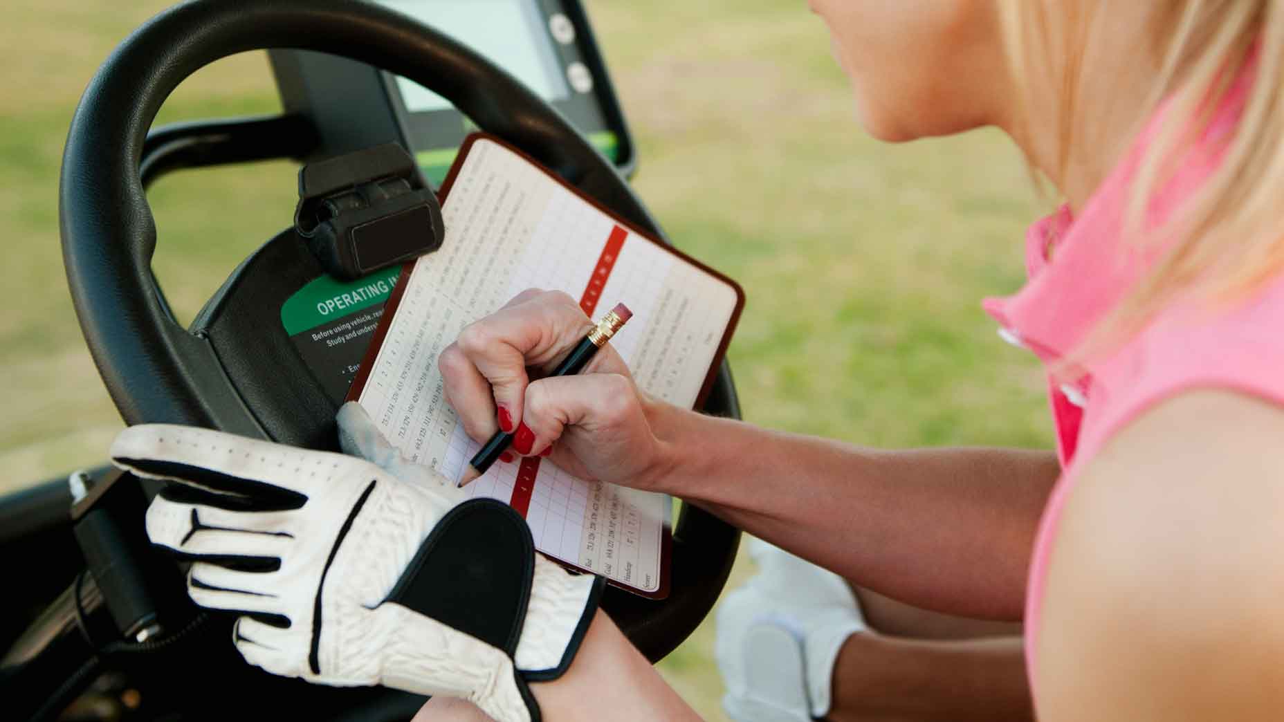 woman writing scorecard