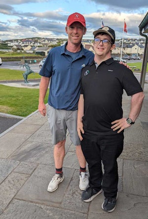 Lahinch caddie Dave O’Brien and Jamie pose for a photo.