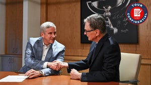 PGA Tour commissioner Jay Monahan shakes hands with John Henry.
