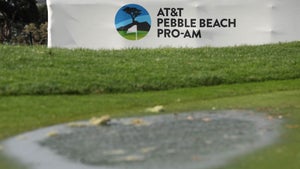 A puddle in front of a sign for the AT&T Pebble Beach Pro-Am.