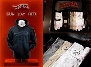 Sun Day Red by Tiger Woods in partnership with TaylorMade. Black hoodie and golf gloves are shown.