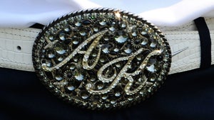 close up of anthony kim's blinged-out belt buckle