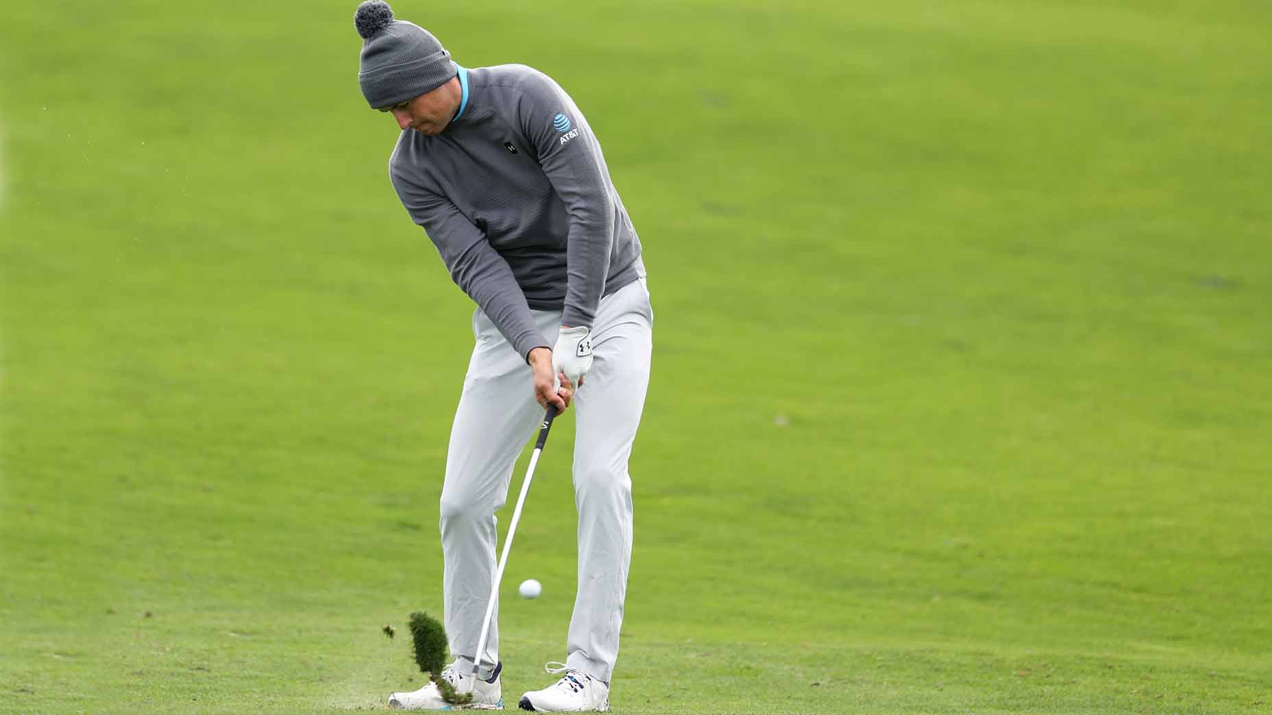 jordan spieth takes a divot in the fairway during the 2024 pebble beach pro-am