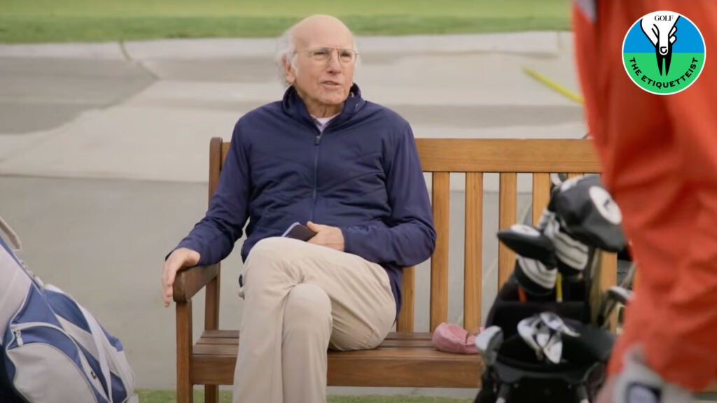 larry david sitting on bench at golf course