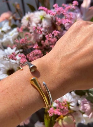 Ruvido golf bracelets shown paired together in gold and silver.