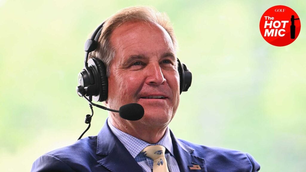jim nantz smiles from the booth at the memorial tournament in a blue suit and yellow tie