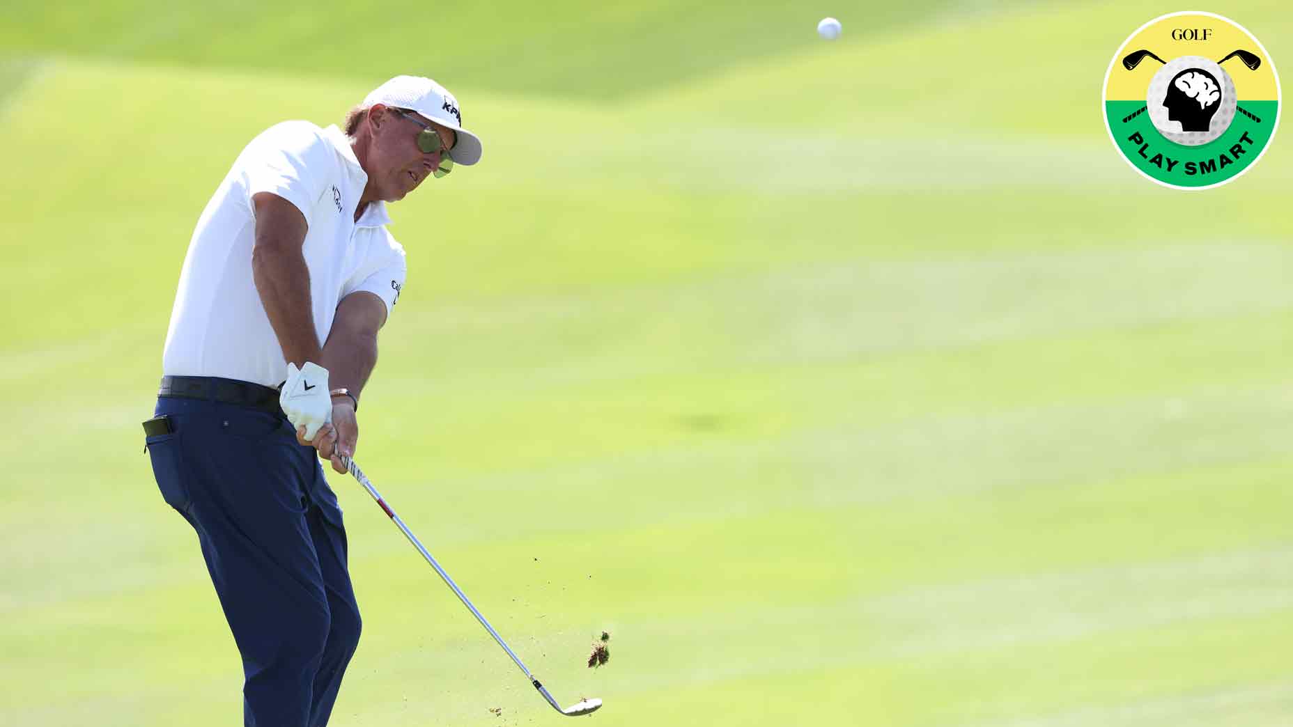 phil mickelson hits a chip shot during a practice round for the 2022 Saudi International