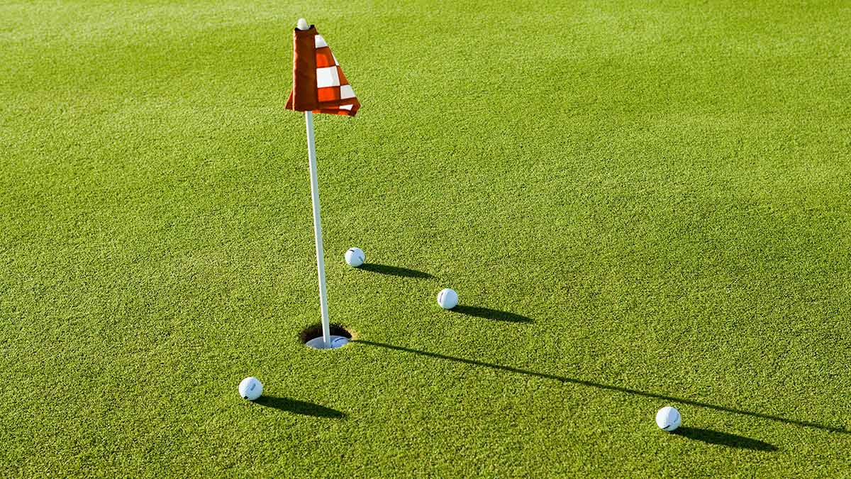 golf balls on a practice putting green