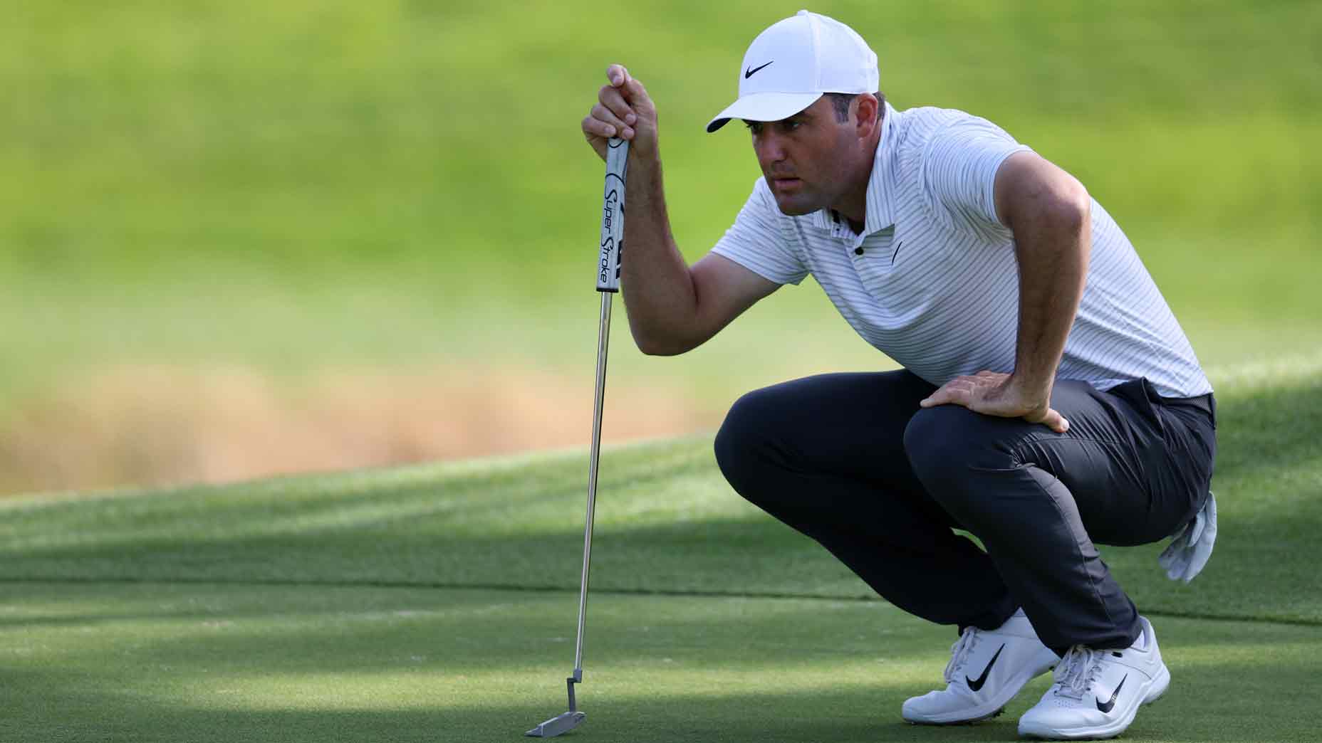 scottie scheffler marks a putt during the 2024 genesis invitational