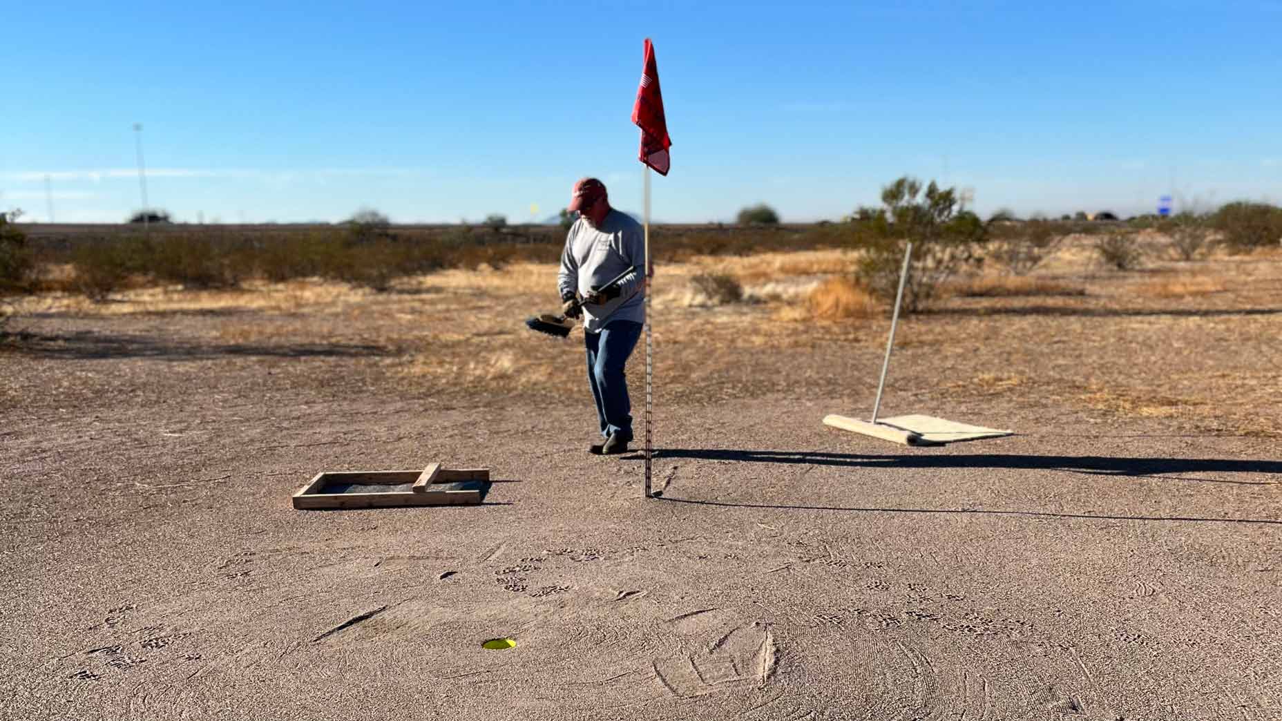 Maintaining the sand greens at Snakehole Golf Course