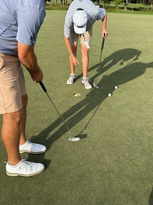 Joe Hallett works on his putting stroke by making a tennis ball in practice