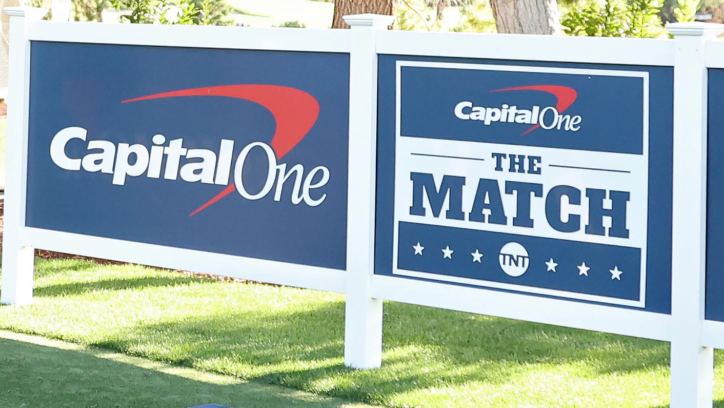 A view of a Capitol One's The Match sign on a golf course