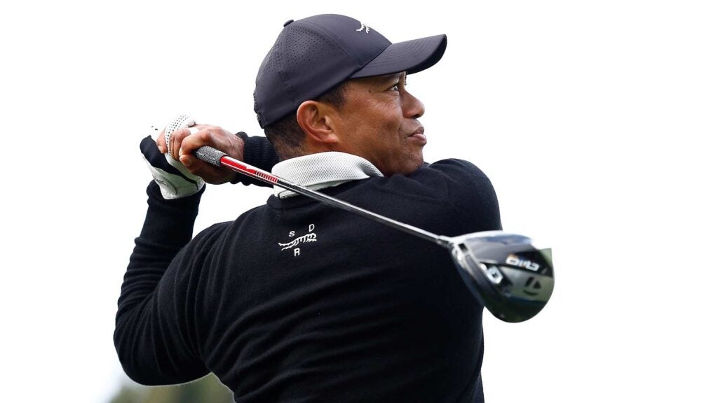 Tiger Woods holds swing finish while watching drive at 2024 Genesis Invitational