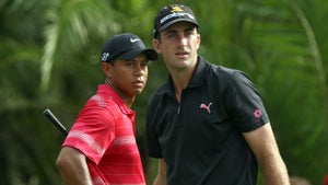 Pro golfers Tiger Woods and Geoff Ogilvy at a PGA Tour tournament.