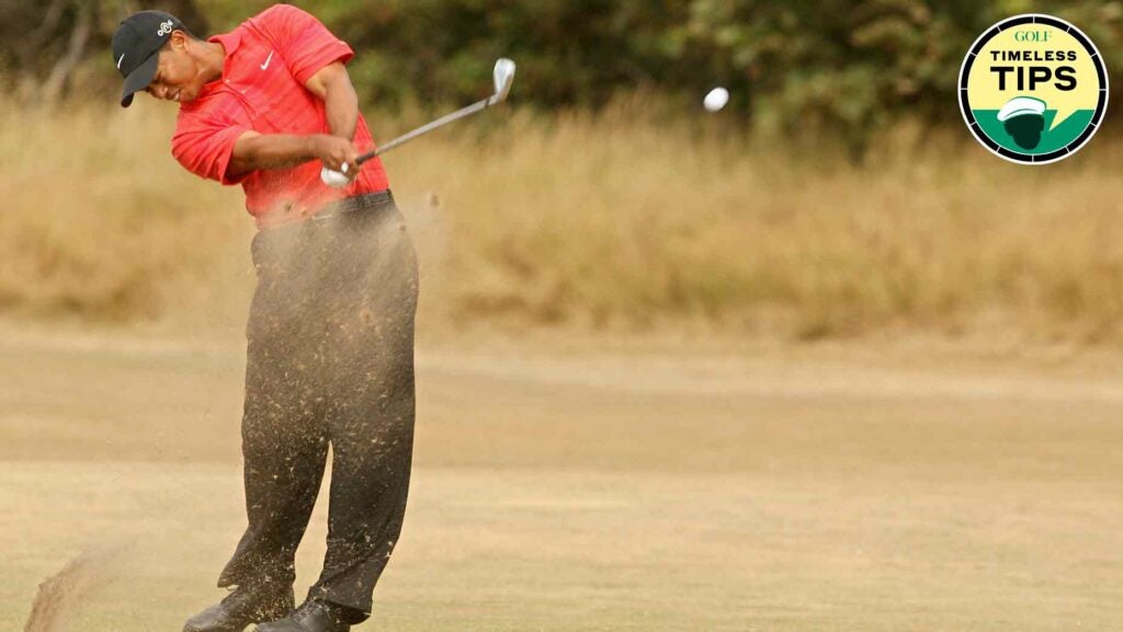 tiger woods, dressed in red and black, hits shot during the 2006 open championship.