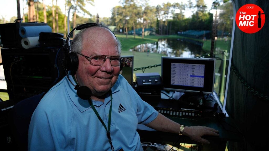 verne lundquist smiles in booth at the Masters in front of Augusta National's 16th hole