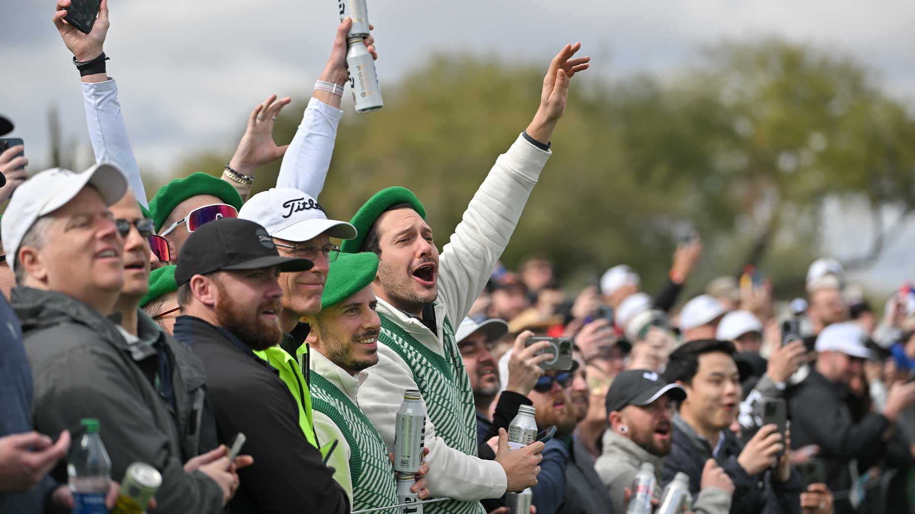 row of fans drunkenly screams and cheers at waste management phoenix open