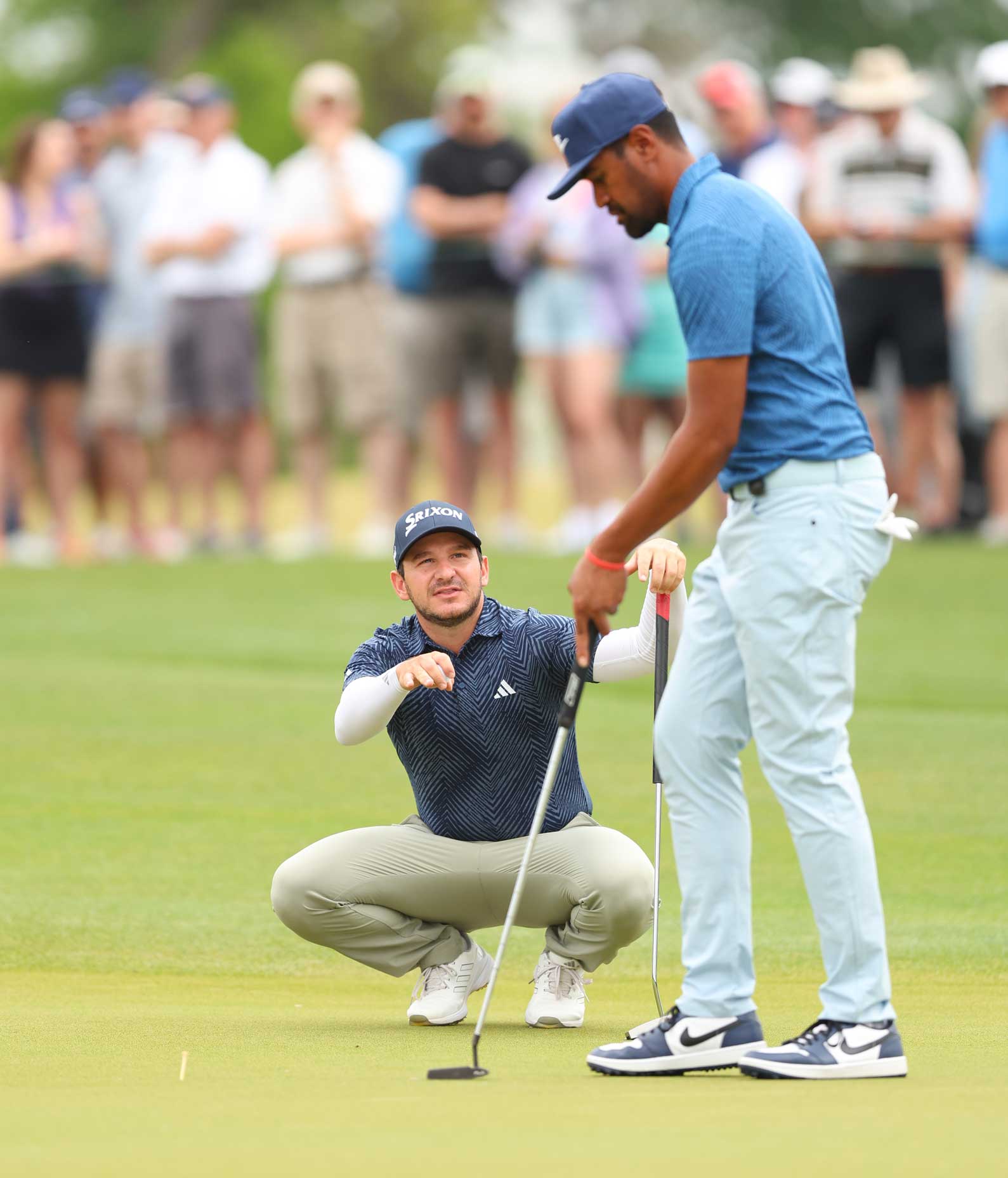 Tony Finau and Alejandro Tosti talk during the Houston Open.