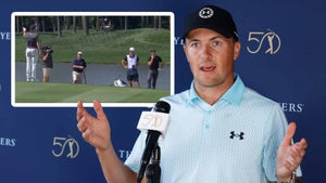 Jordan Spieth speaks to the media at the Players with an image of him and Rory McIlroy discussing a drop.
