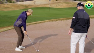 kelnan mcdonagh watches GOLF editor Zephyr Melton as he hits a long bunker shot