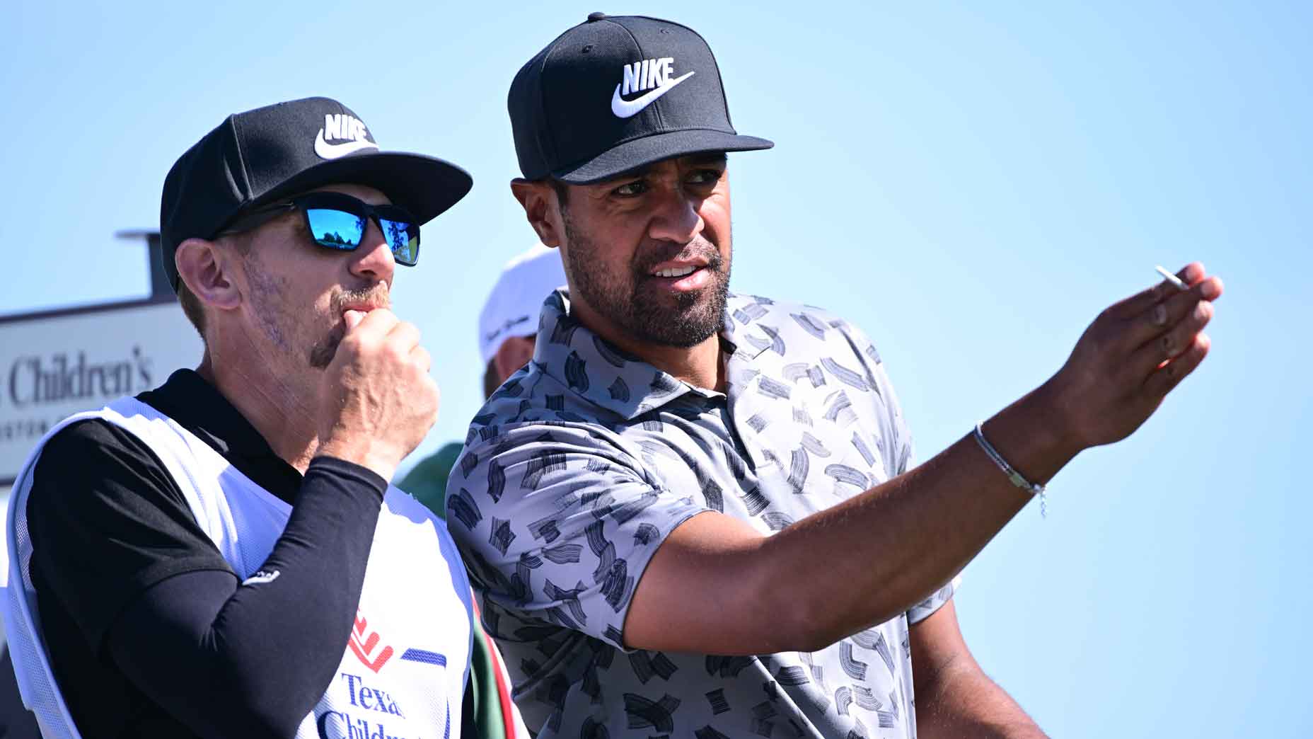 Tony Finau of the United States and caddie Mark Urbanek plan a shot from the fourth tee during the second round of the Texas Children's Houston Open at Memorial Park Golf Course on March 29, 2024 in Houston, Texas