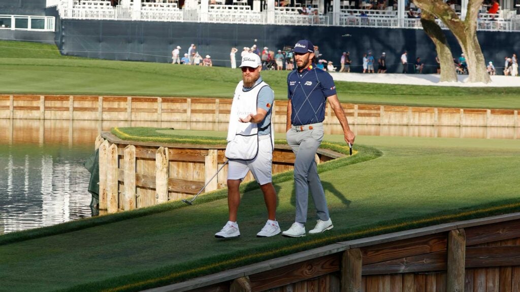 max homa walks off 17th green at TPC sawgrass with caddie joe greiner