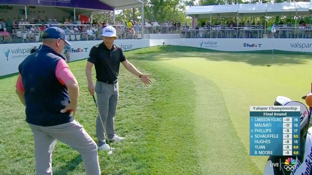 PGA Tour pro Peter Malnati discusses a free drop with a rules official on Sunday at the 2024 Valspar Championship at Innisbrook Resort